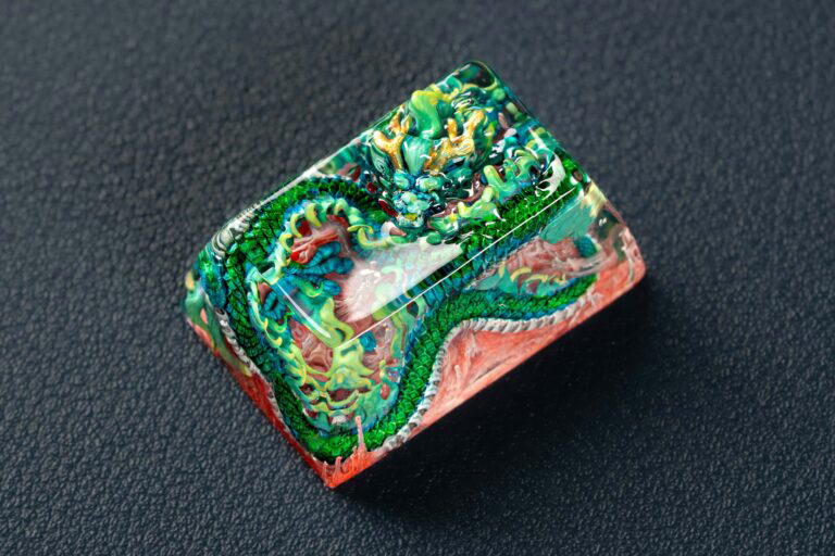 Colorful dragon carved resin art block on dark background.