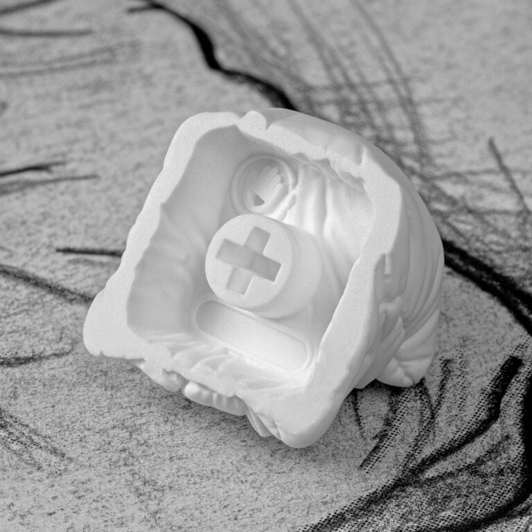 White pillow keycaps on the hand writings art