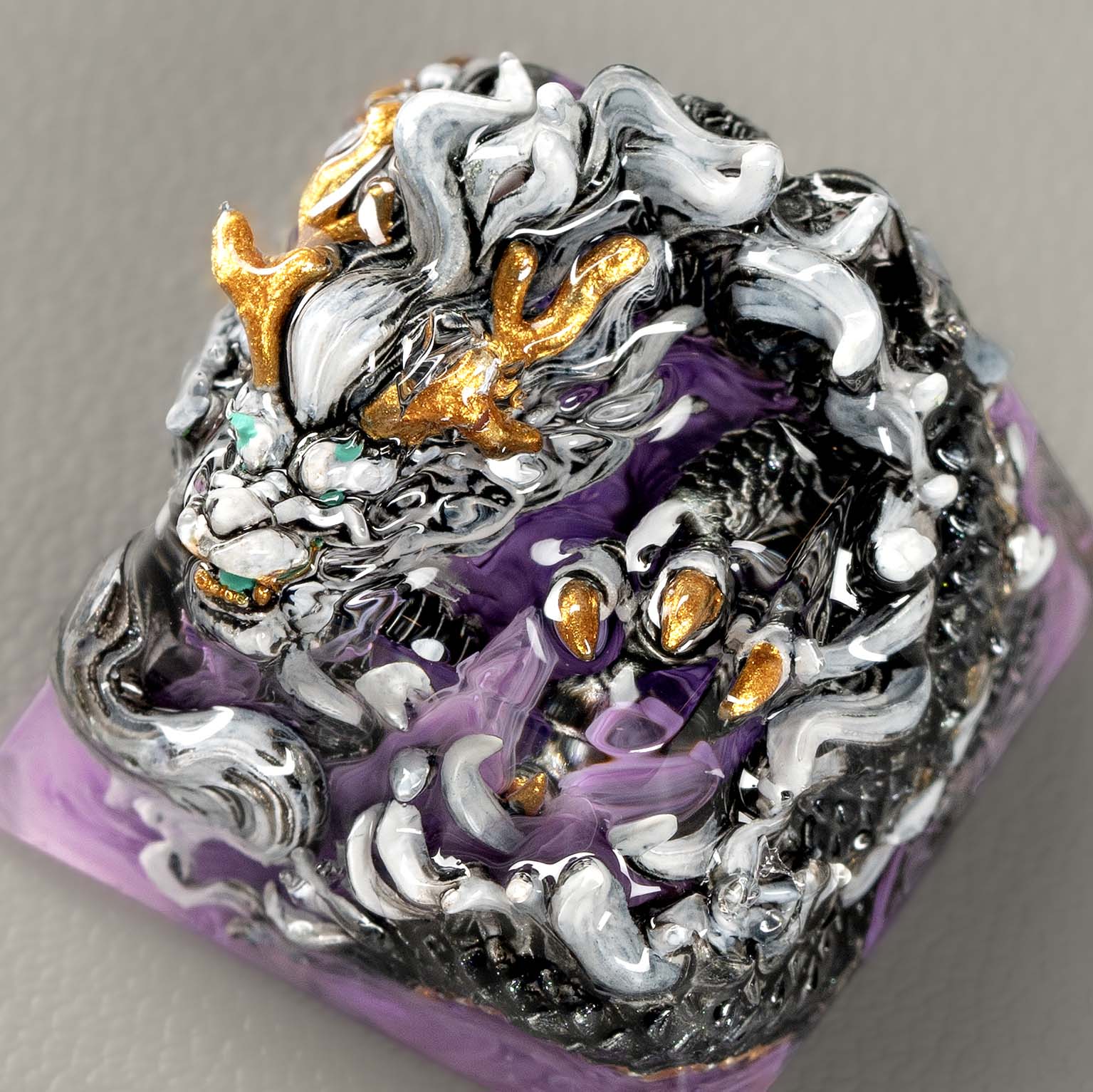 Intricate dragon-themed sculpted purple bracelet with gems.