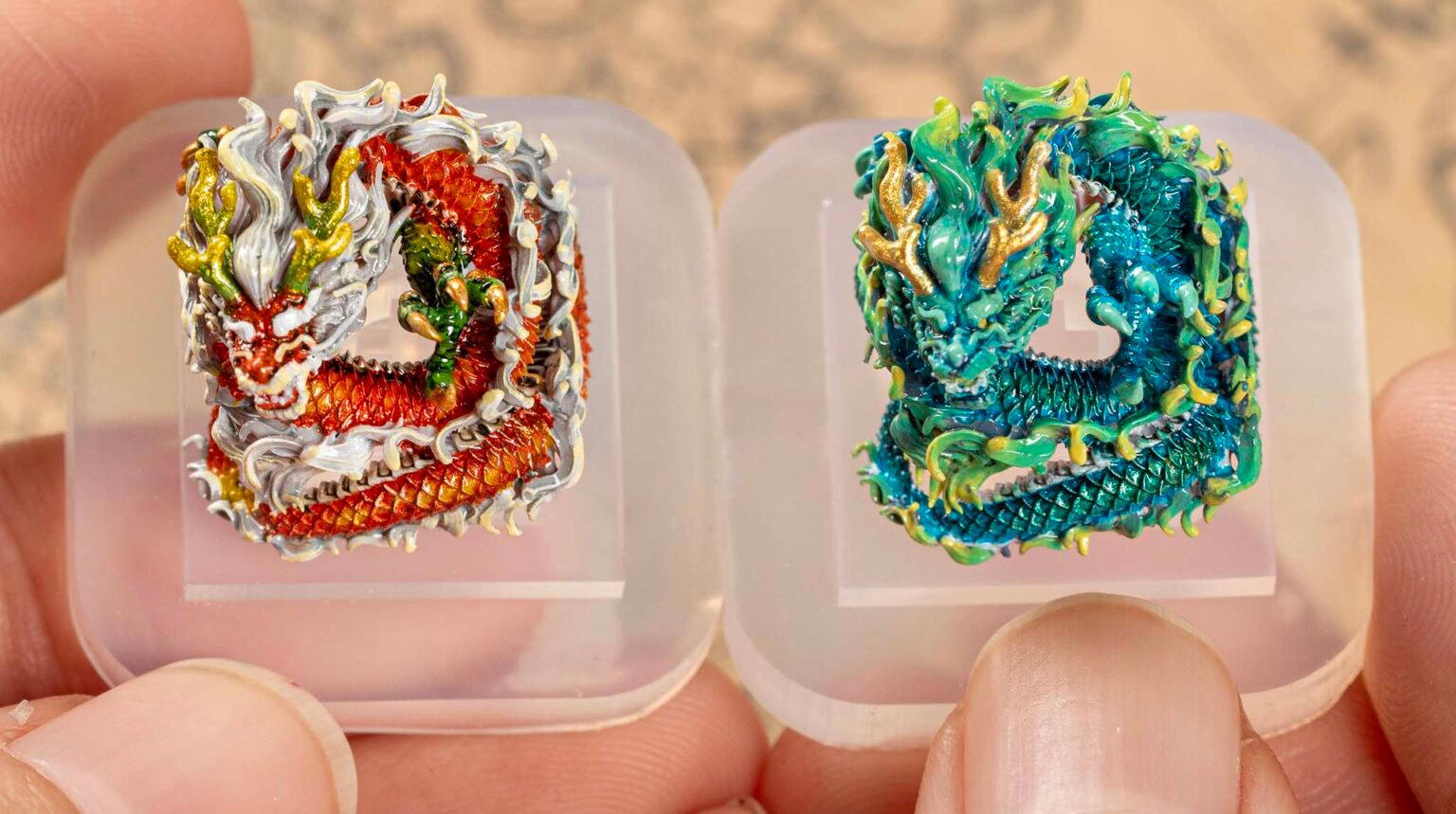 Colorful miniature dragon keycaps in fingers